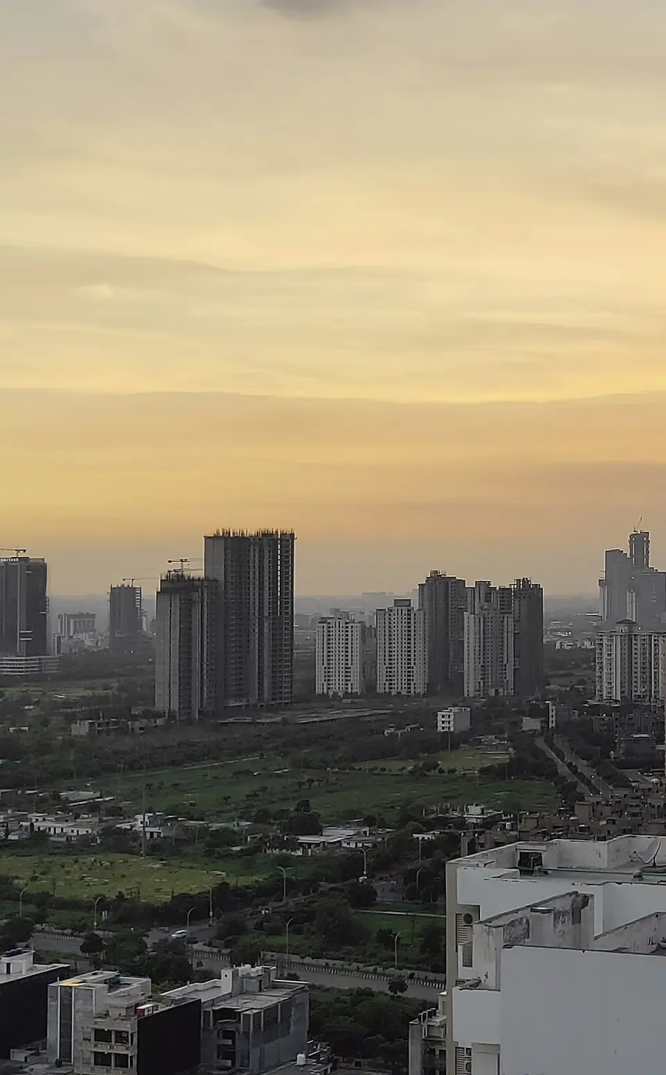 Apartment towers and rooftops in Noida at dusk