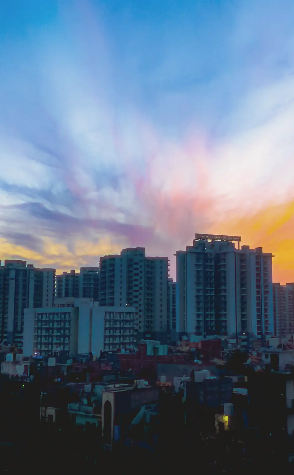 Residential towers against a sunset sky in Gurugram